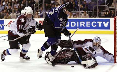 LOS ANGELES – JANUARY 29: Scott Barney, #62 of the Los Angeles Kings, tries to put the loose puck past goaltender David Aebischer #1 of the Colorado Avalanche in the second period on January 29, 2004, at Staples Center in Los Angeles, California. (Photo by Victor Decolongon/Getty Images)