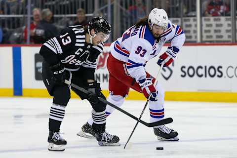 Mar 22, 2022; Newark, New Jersey, USA; New Jersey Devils center Nico Hischier (13) and New York Rangers center Mika Zibanejad (93) battle for the puck during the third period at Prudential Center. Mandatory Credit: Tom Horak-USA TODAY Sports