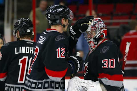 Jan 8, 2016; Raleigh, NC, USA; Carolina Hurricanes goalie Cam Ward (30) is congratulated by teammate forward Eric Staal (12) after the game against the Columbus Blue Jackets at PNC Arena. The Carolina Hurricanes defeated the Columbus Blue Jackets 4-1. Mandatory Credit: James Guillory-USA TODAY Sports