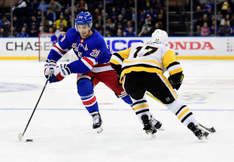 NEW YORK, NEW YORK – NOVEMBER 12: Chris Kreider #20 of the New York Rangers controls the puck with pressure from Bryan Rust #17 of the Pittsburgh Penguins during their game at Madison Square Garden on November 12, 2019 in New York City. (Photo by Emilee Chinn/Getty Images)