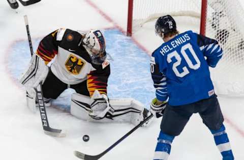 EDMONTON, AB – DECEMBER 25: Samuel Helenius #20 of Finland takes a shot on goaltender Arno Tiefensee #1 of Germany during the 2021 IIHF World Junior Championship at Rogers Place on December 25, 2020 in Edmonton, Canada. (Photo by Codie McLachlan/Getty Images)