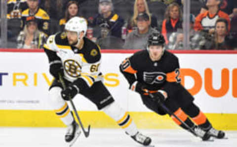 Apr 9, 2023; Philadelphia, Pennsylvania, USA; Boston Bruins defenseman Jakub Zboril (67) with puck against Philadelphia Flyers left wing Kieffer Bellows (20) during the first period at Wells Fargo Center. Mandatory Credit: Eric Hartline-USA TODAY Sports