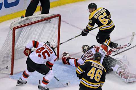 BOSTON – JANUARY 23: Boston Bruins’ Brad Marchand (63) gets the puck past Devils’ goalie Cory Schneider late in the second period to give Boston a 3-2 lead. The Boston Bruins host the New Jersey Devils in a regular season NHL hockey game at TD Garden in Boston on Jan. 23, 2018. (Photo by Jim Davis/The Boston Globe via Getty Images)