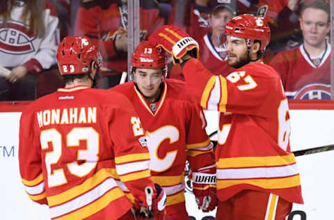 Mar 9, 2017; Calgary, Alberta, CAN; Calgary Flames left wing Johnny Gaudreau (13) celebrates his third period goal with right wing Michael Frolik (67) and center Sean Monahan (23) against the Montreal Canadiens at Scotiabank Saddledome. The Flames won 5-0. Mandatory Credit: Candice Ward-USA TODAY Sports