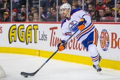 Dec 27, 2015; Calgary, Alberta, CAN; Edmonton Oilers defenseman Justin Schultz (19) controls the puck against the Calgary Flames during the first period at Scotiabank Saddledome. Calgary Flames won 5-3. Mandatory Credit: Sergei Belski-USA TODAY Sports