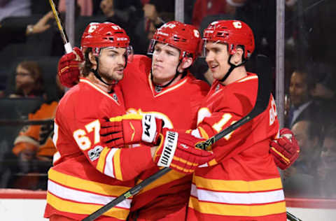 Feb 15, 2017; Calgary, Alberta, CAN; Calgary Flames left wing Matthew Tkachuk (19) celebrates with right wing Michael Frolik (67) and center Mikael Backlund (11) after scoring a goal in the first period against the Philadelphia Flyers at Scotiabank Saddledome. Mandatory Credit: Candice Ward-USA TODAY Sports