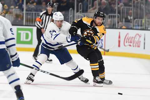 BOSTON, MA – OCTOBER 22: Matt Grzelcyk #48 of the Boston Bruins passes the puck against Kasperi Kapanen #24 of the Toronto Maple Leafs at the TD Garden on October 22, 2019 in Boston, Massachusetts. (Photo by Steve Babineau/NHLI via Getty Images)