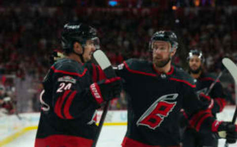 Feb 21, 2023; Raleigh, North Carolina, USA; Carolina Hurricanes center Seth Jarvis (24) is congratulated by defenseman Calvin de Haan (44) after his goal against the St. Louis Blues during the third period at PNC Arena. Mandatory Credit: James Guillory-USA TODAY Sports