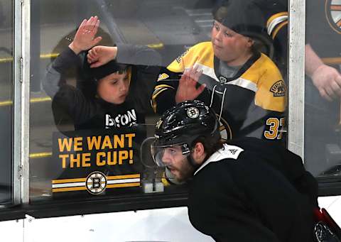 BOSTON, MA – MAY 23: Two fans get a close view of the game and the Boston Bruins’ Jake DeBrusk at ice level in the second period of a scrimmage ahead of the start of the 2019 NHL Stanley Cup Finals at TD Garden in Boston on May 23, 2019. (Photo by John Tlumacki/The Boston Globe via Getty Images)