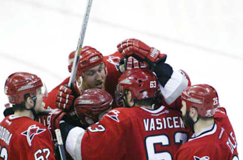 DETROIT, MI – JUNE 4: The Carolina Hurricanes celebrate after Ron Francis #10 of the Carolina Hurricanes scores the game winning goal against the Detroit Red Wings during game 1 of the 2002 Stanley Cup Finals on June 4, 2002 at Joe Louis Arena in Detroit, Michigan. The Hurricanes defeated the Red Wings 3-2. (Photo by Tom Pidgeon/Getty Images/NHLI)