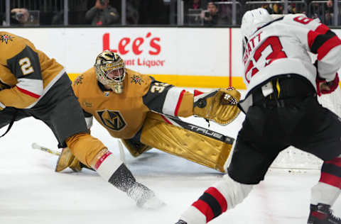 Mar 3, 2023; Las Vegas, Nevada, USA; Vegas Golden Knights goaltender Adin Hill (33) makes a save against New Jersey Devils left wing Jesper Bratt (63) during the second period at T-Mobile Arena. Mandatory Credit: Stephen R. Sylvanie-USA TODAY Sports