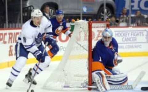 Oct 30, 2016; Brooklyn, NY, USA; Toronto Maple Leafs center Zach Hyman (11) plays the puck behind New York Islanders goalie Thomas Greiss (1) during the third period at Barclays Center. Mandatory Credit: Brad Penner-USA TODAY Sports