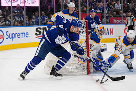 Mar 13, 2023; Toronto, Ontario, CAN; Buffalo Sabres defenseman Jacob Bryson (78) knocks the puck away from Toronto Maple Leafs forward David Kampf (64) as Buffalo Sabres goaltender Craig Anderson (41) looks on during the third period at Scotiabank Arena. Mandatory Credit: John E. Sokolowski-USA TODAY Sports