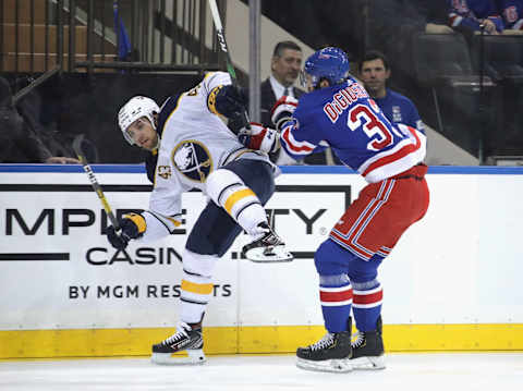 Phil Di Giuseppe of the New York Rangers checks Conor Sheary of the Buffalo Sabres