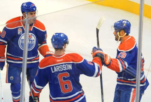 Oct 4, 2016; Edmonton, Alberta, CAN; Edmonton Oilers left winger Patrick Maroon (19) celebrates with right winger Nail Yakupov (10 ) and defenceman Adam Larsson (6) after scoring a goal during the first period of a preseason hockey game at Rogers Place. Mandatory Credit: Walter Tychnowicz-USA TODAY Sports