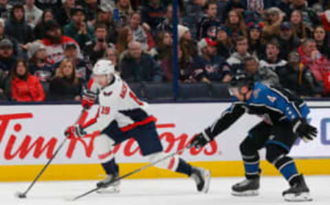 Jan 31, 2023; Columbus, Ohio, USA; Washington Capitals center Nicklas Backstrom (19) carries the puck around the defense of Columbus Blue Jackets defenseman Vladislav Gavrikov (4) during the first period at Nationwide Arena. Mandatory Credit: Russell LaBounty-USA TODAY Sports