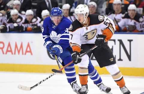 Dec 19, 2016; Toronto, Ontario, CAN; Anaheim Ducks forward Rickard Rakell (67) skates with the puck as Toronto Maple Leafs forward Frederik Gauthier (33) lefts his stick in the first period at Air Canada Centre. Mandatory Credit: Dan Hamilton-USA TODAY Sports