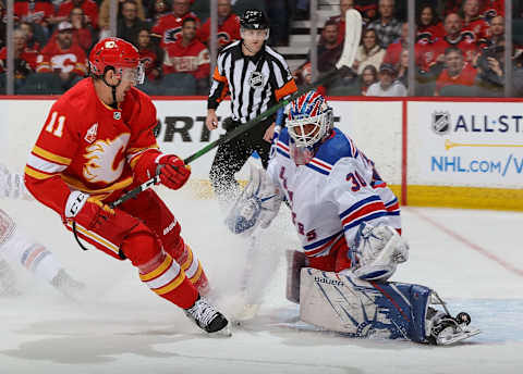 Mikael Backlund #11 of the Calgary Flames scores shorthanded against Henrik Lundqvist #30 of the New York Rangers