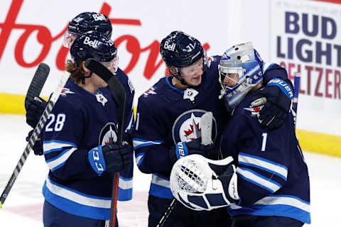 Winnipeg Jets. Nathan Beaulieu (28), Evgeny Svechnikov (71), and Eric Comrie (1). Mandatory Credit: James Carey Lauder-USA TODAY Sports