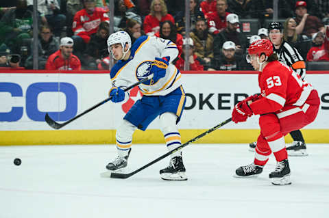 Apr 6, 2023; Detroit, Michigan, USA; Buffalo Sabres center Dylan Cozens (24) shoots as Detroit Red Wings defenseman Moritz Seider (53) defends during the third period at Little Caesars Arena. Mandatory Credit: Tim Fuller-USA TODAY Sports