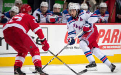 DETROIT, MI – FEBRUARY 1: Mika Zibanejad #93 of the New York Rangers skates up ice with the puck in front of Patrik Nemeth #22 of the Detroit Red Wings during an NHL game at Little Caesars Arena on February 1, 2020 in Detroit, Michigan. (Photo by Dave Sandford/NHLI via Getty Images)