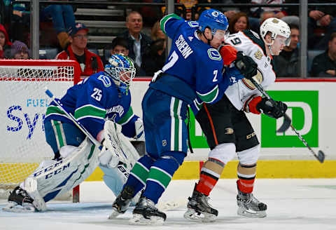 VANCOUVER, BC – February 25: Luke Schenn #2 of the Vancouver Canucks checks Max Jones #49 of the Anaheim Ducks during their NHL game at Rogers Arena February 25, 2019, in Vancouver, British Columbia, Canada. Vancouver won 4-0. (Photo by Jeff Vinnick/NHLI via Getty Images)