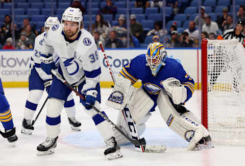 Oct 17, 2023; Buffalo, New York, USA; Tampa Bay Lightning left wing Brandon Hagel (38) and Buffalo Sabres goaltender Devon Levi (27) look for the puck during the first period at KeyBank Center. Mandatory Credit: Timothy T. Ludwig-USA TODAY Sports