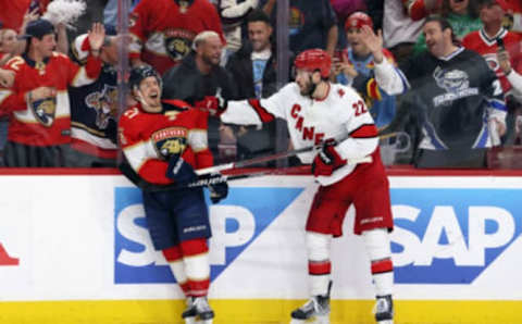 SUNRISE, FLORIDA – MAY 22: Brett Pesce #22 of the Carolina Hurricanes grabs Nick Cousins #21 of the Florida Panthers in the closing seconds of Game Three of the Eastern Conference Final of the 2023 Stanley Cup Playoffs at FLA Live Arena on May 22, 2023 in Sunrise, Florida. (Photo by Bruce Bennett/Getty Images)