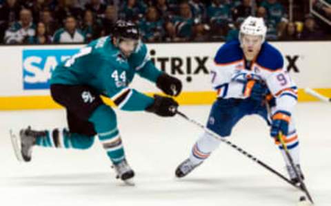 Apr 16, 2017; San Jose, CA, USA; San Jose Sharks defenseman Marc-Edouard Vlasic (44) and Edmonton Oilers center Connor McDavid (97) vie for possession in the second period of game three in the first round of the 2017 Stanley Cup Playoffs at SAP Center at San Jose. Mandatory Credit: John Hefti-USA TODAY Sports