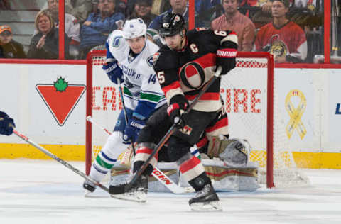 OTTAWA, ON – NOVEMBER 12: Erik Karlsson #65 of the Ottawa Senators blocks a shot as Alex Burrows #14 of the Vancouver Canucks looks for a deflection on November 12, 2015. (Photo by Andre Ringuette/NHLI via Getty Images)