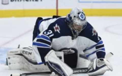 Apr 9, 2016; Los Angeles, CA, USA; Winnipeg Jets goalie Ondrej Pavelec (31) covers up the puck during the second period against the Los Angeles Kings at Staples Center. Mandatory Credit: Kelvin Kuo-USA TODAY Sports