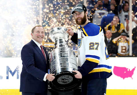 BOSTON, MASSACHUSETTS – JUNE 12: NHL commisoner Gary Bettman presents Alex Pietrangelo #27 of the St. Louis Blues with the Stanley Cup after defeating the Boston Bruins 4-1 to win Game Seven of the 2019 NHL Stanley Cup Final at TD Garden on June 12, 2019 in Boston, Massachusetts. (Photo by Bruce Bennett/Getty Images)