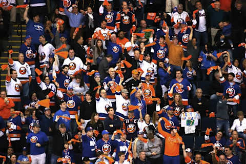 Apr 25, 2015; Uniondale, NY, USA; Fans of the New York Islanders celebrate after the Islanders defeated the Washington Capitals in game six of the first round of the 2015 Stanley Cup Playoffs at Nassau Veterans Memorial Coliseum. The Islanders defeated the Capitals 3-1.Mandatory Credit: Andy Marlin-USA TODAY Sports