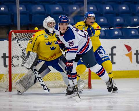 PLYMOUTH, MI – JULY 27 Carl Lindbom #35 of Sweden follows the play as teammate Lucas Ölvestad #7 battles in front of the net with Sasha Pastujov #29 of USA-White during the World Junior Summer Showcase game one at USA Hockey Arena on July 27, 2021 in Plymouth, Michigan. (Photo by Dave Reginek/Getty Images)