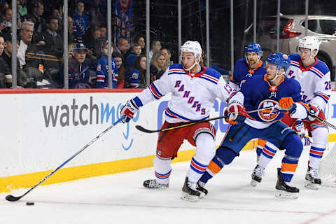 BROOKLYN, NY – APRIL 05: New York Rangers Center Kevin Hayes (13) brings the puck out from behind the goal defended by New York Islanders Winger Chris Wagner (21) during the third period at the Barclays Center in Brooklyn,NY (Photo by Dennis Schneidler/Icon Sportswire via Getty Images)