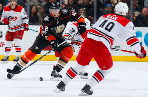 ANAHEIM, CA – DECEMBER 11: Josh Manson #42 of the Anaheim Ducks skates with the puck against Victor Rask #49 of the Carolina Hurricanes during the game on December 11, 2017, at Honda Center in Anaheim, California. (Photo by Debora Robinson/NHLI via Getty Images) *** Local Caption ***