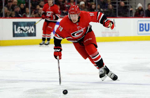 RALEIGH, NC – DECEMBER 07: Ryan Dzingel #18 of the Carolina Hurricanes tries to control a loose puck during an NHL game against the Minnesota Wild on December 7, 2019 at PNC Arena in Raleigh, North Carolina. (Photo by Gregg Forwerck/NHLI via Getty Images)