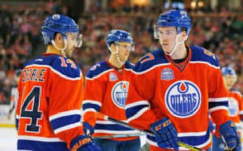 Apr 6, 2016; Edmonton, Alberta, CAN; Edmonton Oilers forward Jordan Eberle (14) and forward Connor McDavid (97) discuss a plan prior to a face-off against the Vancouver Canucks at Rexall Place. Mandatory Credit: Perry Nelson-USA TODAY Sports