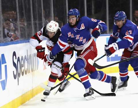 NEW YORK, NEW YORK – SEPTEMBER 18: Mika Zibanejad #93 of the New York Rangers checks Nico Hischier #13 of the New Jersey Devils during the first period at Madison Square Garden on September 18, 2019 in New York City. (Photo by Bruce Bennett/Getty Images)