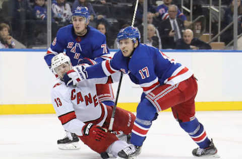 NEW YORK, NEW YORK – NOVEMBER 27: Jesper Fast #17 of the New York Rangers gets his glove up on Warren Foegele #13 of the Carolina Hurricanes during the third period at Madison Square Garden on November 27, 2019 in New York City. The Rangers defeated the Hurricanes 3-2. (Photo by Bruce Bennett/Getty Images)