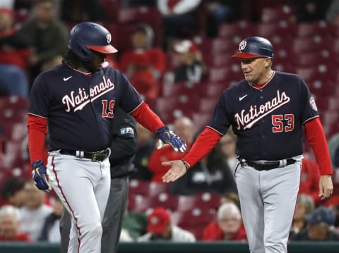 Sep 23, 2021; Cincinnati, Ohio, USA; Washington Nationals first baseman Josh Bell (19) reacts with first base coach Randy Knorr (53) after hitting a single against the Cincinnati Reds during the seventh inning at Great American Ball Park. Mandatory Credit: David Kohl-USA TODAY Sports