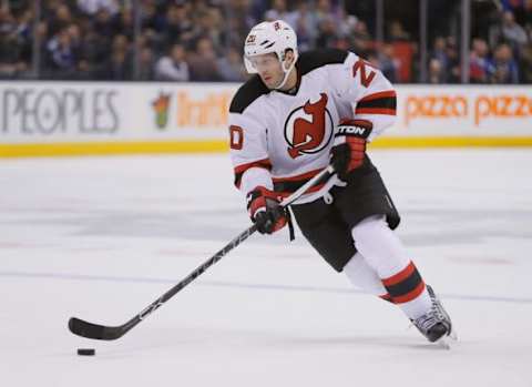 Dec 8, 2015; Toronto, Ontario, CAN; New Jersey Devils forward Lee Stempniak (20) carries the puck against the Toronto Maple Leafs at the Air Canada Centre. Toronto defeated New Jersey 3-2 in an overtime shootout. Mandatory Credit: John E. Sokolowski-USA TODAY Sports