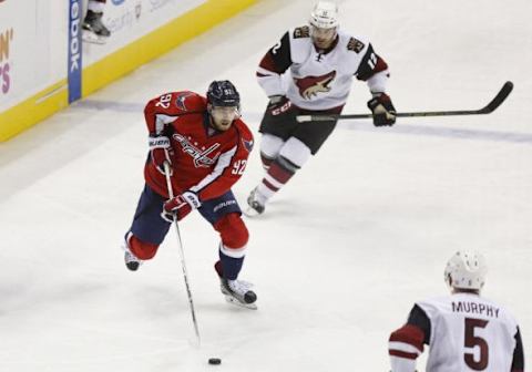 Feb 22, 2016; Washington, DC, USA; Washington Capitals center Evgeny Kuznetsov (92) skates with the puck as Arizona Coyotes center Brad Richardson (12) chases in the third period at Verizon Center. The Capitals won 3-2. Mandatory Credit: Geoff Burke-USA TODAY Sports