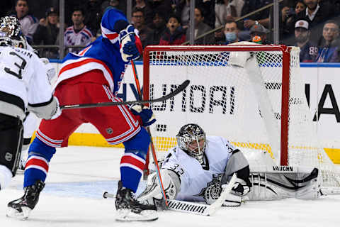 Jan 24, 2022; New York, New York, USA; Los Angeles Kings goaltender Jonathan Quick (32) makes a diving save on New York Rangers center Barclay Goodrow (21) during the third period at Madison Square Garden. Mandatory Credit: Dennis Schneidler-USA TODAY Sports