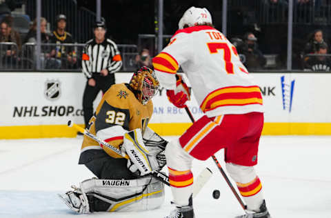 Mar 16, 2023; Las Vegas, Nevada, USA; Vegas Golden Knights goaltender Jonathan Quick (32) makes a save as Calgary Flames right wing Tyler Toffoli (73) looks for a rebound during the first period at T-Mobile Arena. Mandatory Credit: Stephen R. Sylvanie-USA TODAY Sports