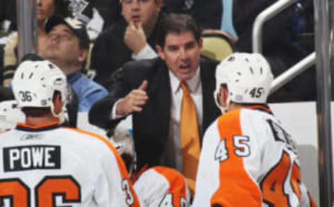 PITTSBURGH – OCTOBER 07: Head coach Peter Laviolette of the Philadelphia Flyers speaks with his players during the game against the Pittsburgh Penguins at the Consol Energy Center on October 7, 2010, in Pittsburgh, Pennsylvania. (Photo by Bruce Bennett/Getty Images)