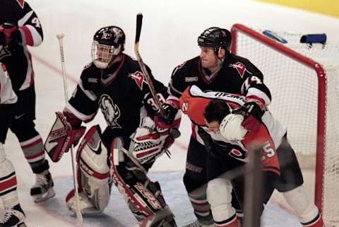 13 Apr 2000: Goallie Dominik Hasek #39 of the Buffalo Sabres watching for a shot on goal while teammate Jay McKee #74 tries to stop Keith Primeau #25 from getting position and the loose puck during the game against the Philadelphia Flyers at the First Union Center in Philadelphia, Pennsylvania. The Flyers defeated the Sabres 2-1.