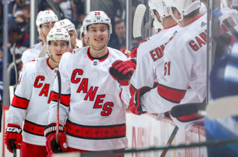 WINNIPEG, MB – DECEMBER 17: Sebastian Aho #20 of the Carolina Hurricanes celebrates his second period goal against the Winnipeg Jets with teammates at the bench at the Bell MTS Place on December 17, 2019 in Winnipeg, Manitoba, Canada. (Photo by Jonathan Kozub/NHLI via Getty Images)