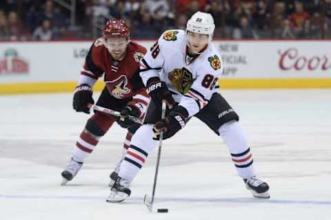 Feb 4, 2016; Glendale, AZ, USA; Chicago Blackhawks right wing Patrick Kane (88) skates past Arizona Coyotes center Max Domi (16) during the third period at Gila River Arena. The Blackhawks won 5-4 in overtime. Mandatory Credit: Joe Camporeale-USA TODAY Sports