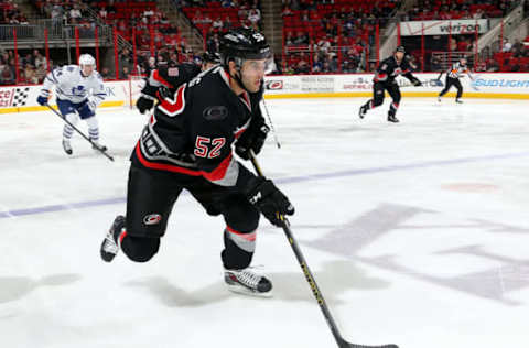 RALEIGH, NC – DECEMBER 18: Justin Shugg #52 of the Carolina Hurricanes moves the puck into the neutral zone during an NHL Game against the Toronto Maple Leafs at PNC Arena on December 18, 2014 in Raleigh, North Carolina. (Photo by Gregg Forwerck/NHLI via Getty Images)